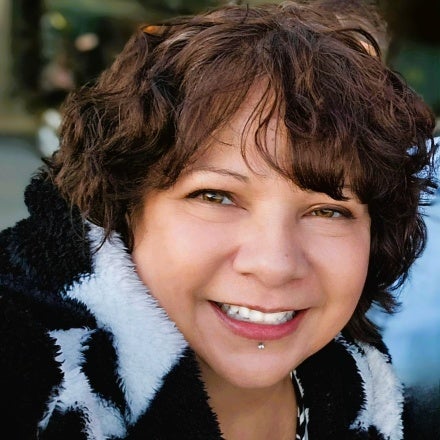 Marlene smiling wearing black/white garment